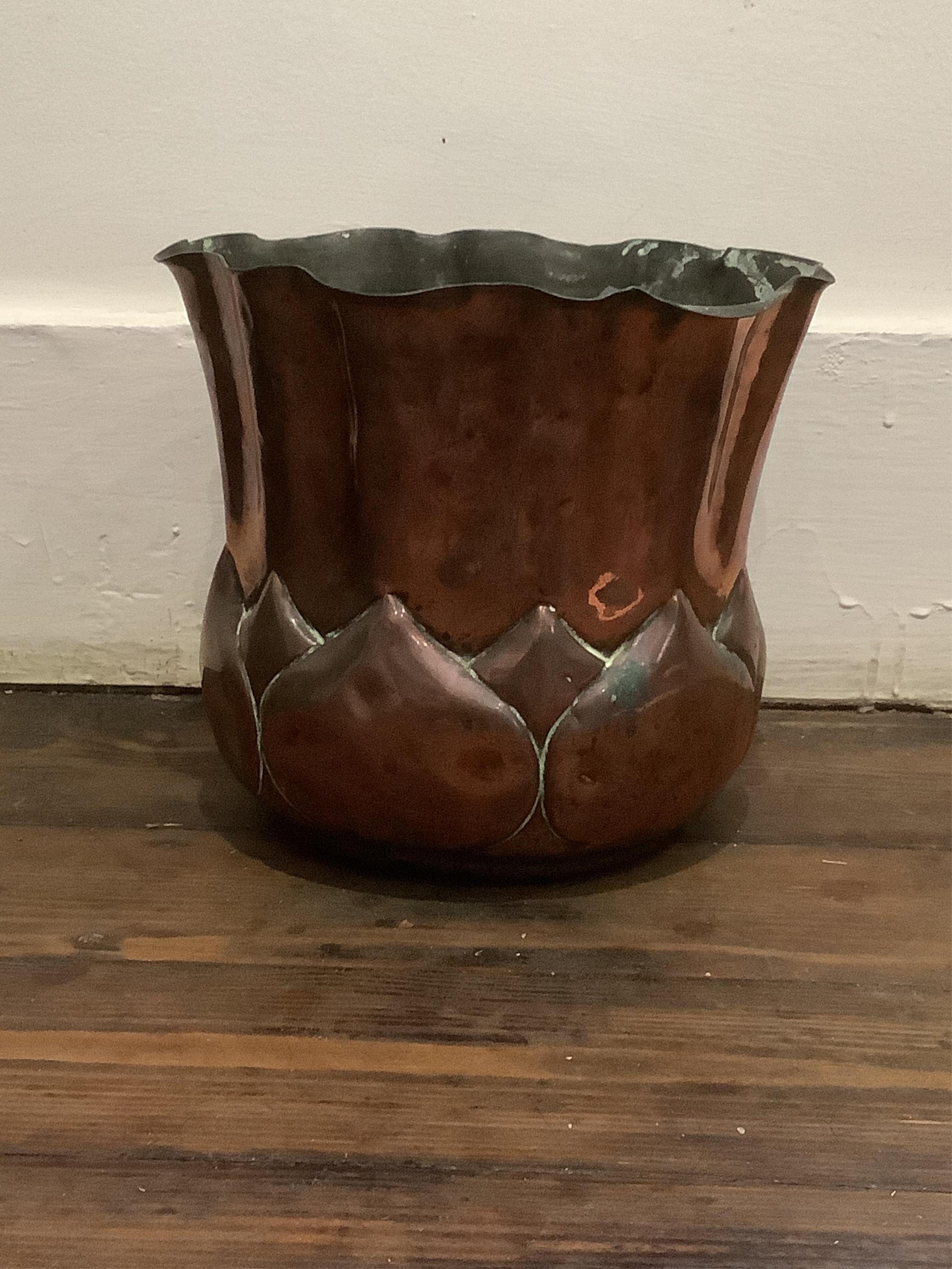 A Wlliam Soutter & Sons Arts and Crafts embossed copper jardiniere, impressed mark to the base, 19cm high. Condition - some oxidised splash marks and minor dents